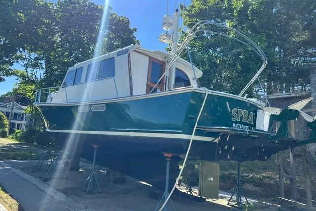 Slide: The Image of Duffy 42 boat from 2000 on stands, green hull, outdoors, sunny day. - 21