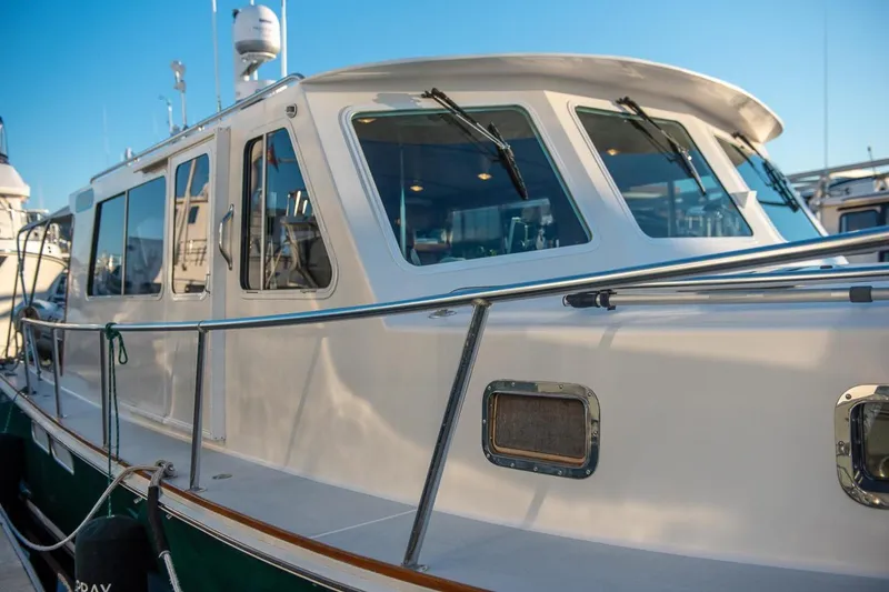 Slide: The Image of 2000 Duffy 42 boat docked, showcasing sleek design and modern windows. - 3