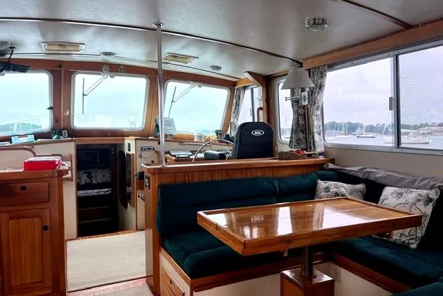 Slide: The Image of Interior of a 2000 Duffy 42 boat with wooden furnishings and a cozy seating area. - 24