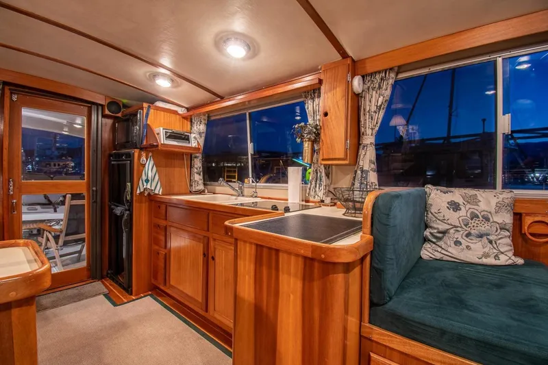 Slide: The Image of Interior of a 2000 Duffy 42 boat with wooden cabinetry and cozy seating. - 7