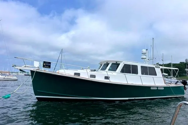 Slide: The Image of Duffy 42 boat from 2000 anchored on calm water under a cloudy sky. - 25