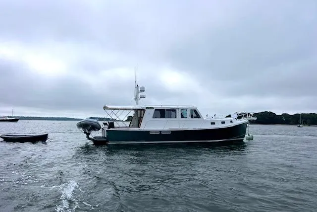 Slide: The Image of Duffy 42 boat from 2000 on calm waters under cloudy skies. - 1