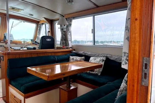 Slide: The Image of Interior of 2000 Duffy 42 boat with cozy seating and wooden table. - 30