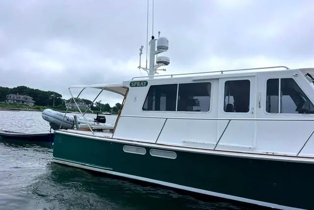 Slide: The Image of Duffy 42 boat from 2000 on calm water, overcast sky in the background. - 4
