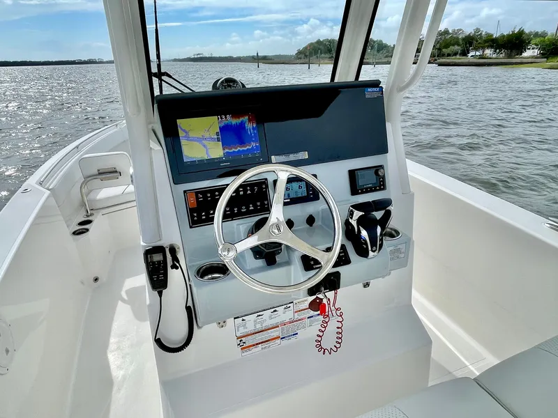 Slide: The Image of 2022 Pursuit S 268 Sport helm on open water. - 17