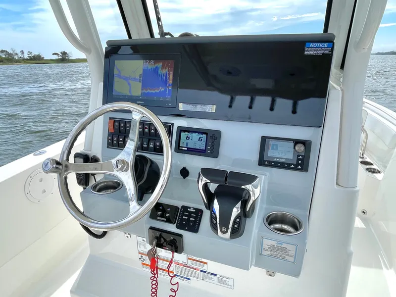 Slide: The Image of 2022 Pursuit S 268 Sport helm console on open water. - 18
