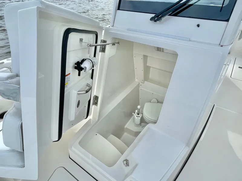 Slide: The Image of Interior of 2022 Pursuit S 268 Sport featuring a toilet. - 44