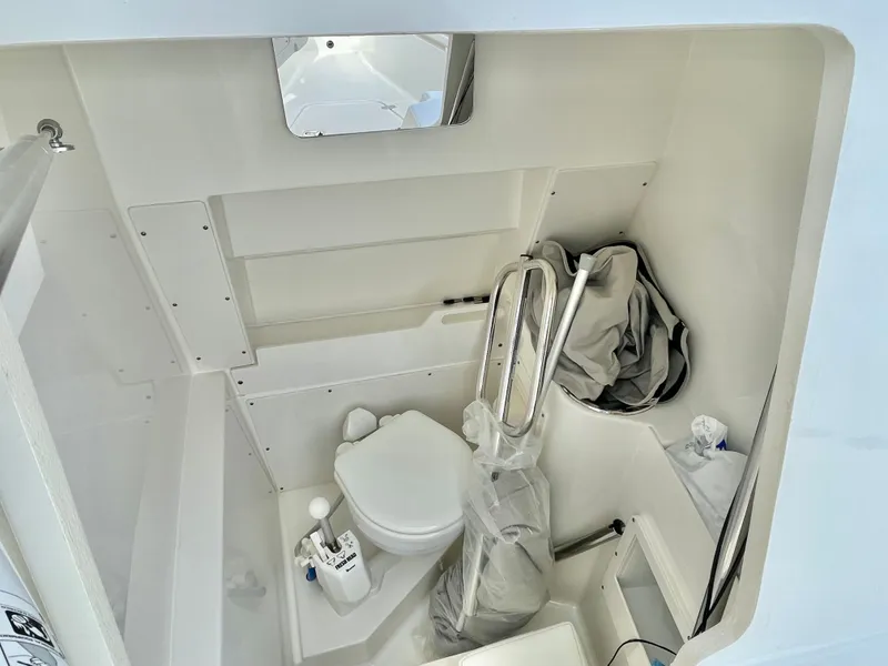 Slide: The Image of Interior of 2022 Pursuit S 268 Sport with toilet and storage. - 45