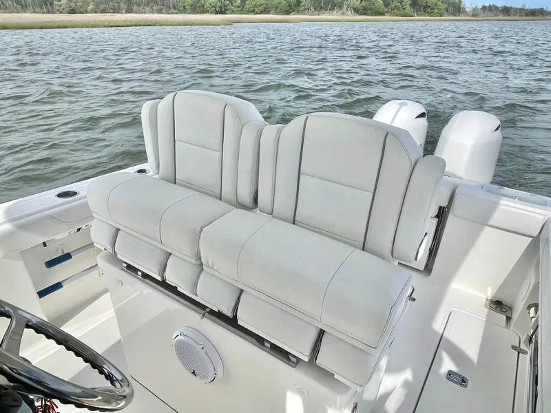 Slide: The Image of 2022 Pursuit S 268 Sport boat with luxurious seating on the water. - 49