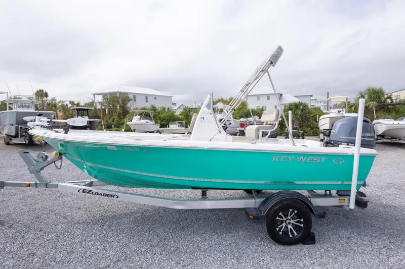 Slide: The Image of 2023 Key West 188 Bay Reef boat on trailer, displayed outdoors. - 12