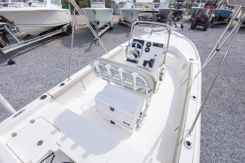 Slide: The Image of 2023 Key West 188 Bay Reef boat interior with console and seating, displayed outdoors. - 15