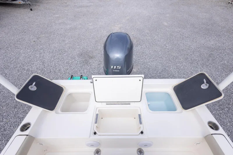 Slide: The Image of 2023 Key West 188 Bay Reef boat with Yamaha 115 engine, featuring storage compartments. - 19