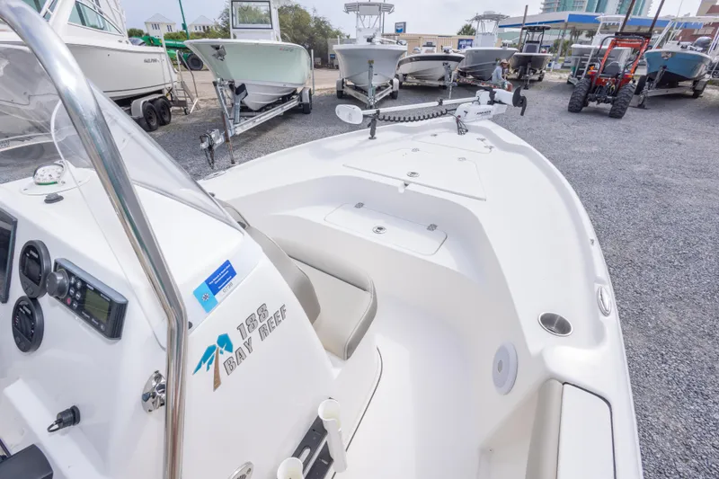 Slide: The Image of 2023 Key West 188 Bay Reef boat displayed in a marina with other vessels. - 24