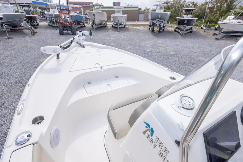 Slide: The Image of 2023 Key West 188 Bay Reef boat on gravel lot, surrounded by other boats. - 25