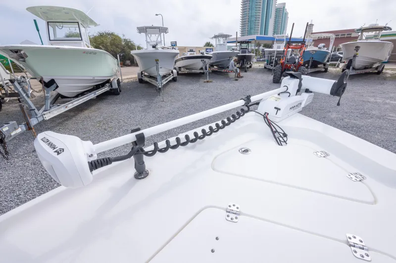 Slide: The Image of 2023 Key West 188 Bay Reef boat with Minn Kota trolling motor in a marina. - 26