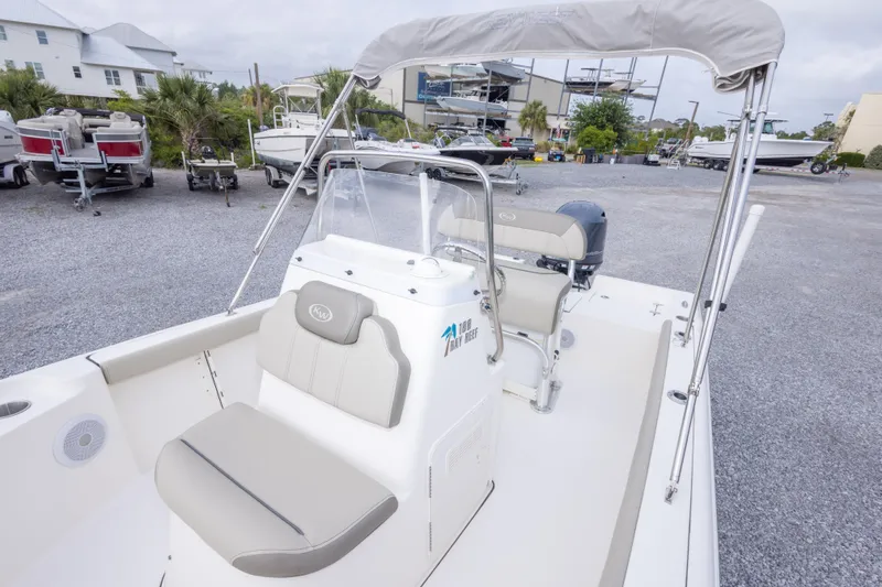 Slide: The Image of 2023 Key West 188 Bay Reef boat with seating and console, parked outdoors. - 29