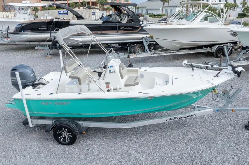 Slide: The Image of 2023 Key West 188 Bay Reef boat on trailer, parked in a marina. - 3