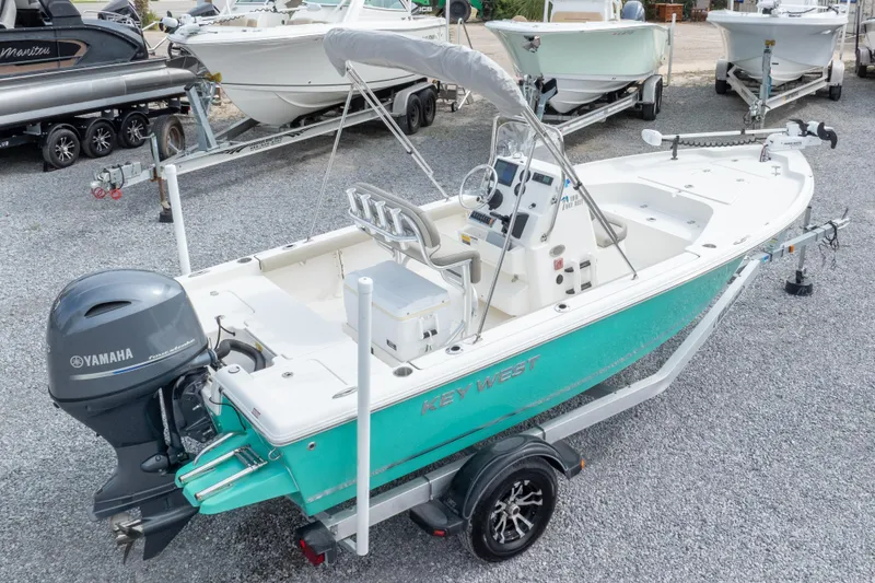 Slide: The Image of 2023 Key West 188 Bay Reef boat with Yamaha engine on trailer, parked on gravel. - 34