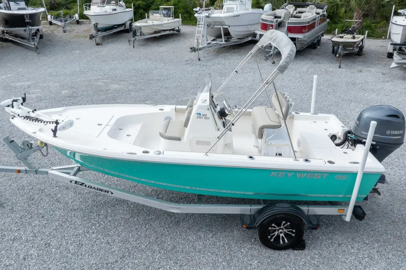 Slide: The Image of 2023 Key West 188 Bay Reef boat on trailer, turquoise hull, Yamaha outboard motor. - 37