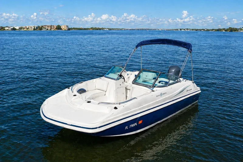 The Image of 2013 Hurricane SunDeck 187 OB boat on calm blue water under clear sky. - 12