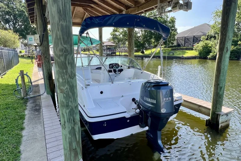 Slide: The Image of 2013 Hurricane SunDeck 187 OB boat docked with Yamaha 115 outboard motor. - 15