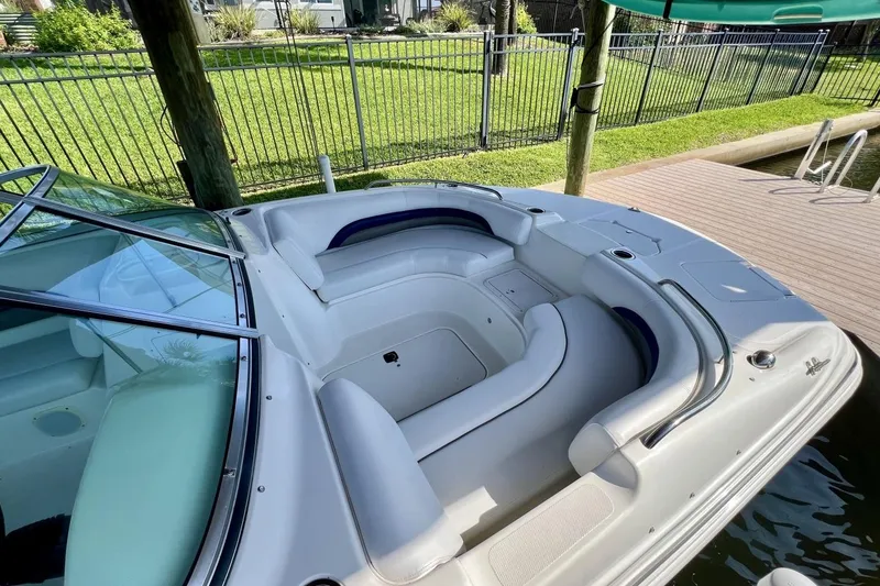 Slide: The Image of 2013 Hurricane SunDeck 187 OB boat with spacious seating, docked near a wooden pier. - 17