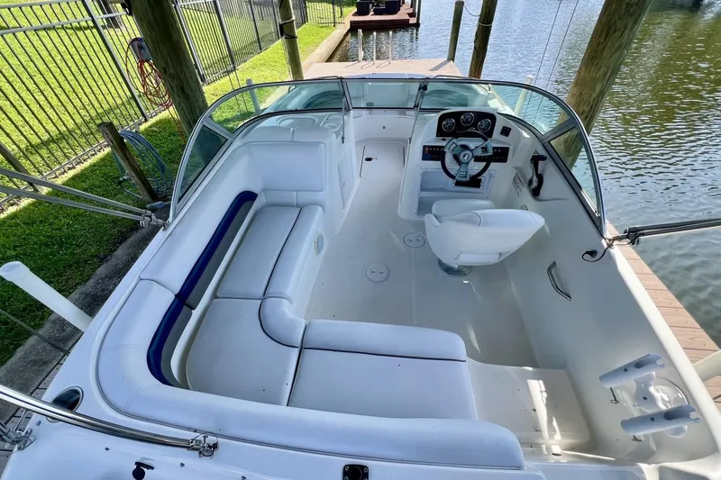 Slide: The Image of 2013 Hurricane SunDeck 187 OB boat interior with white seating and steering console. - 21