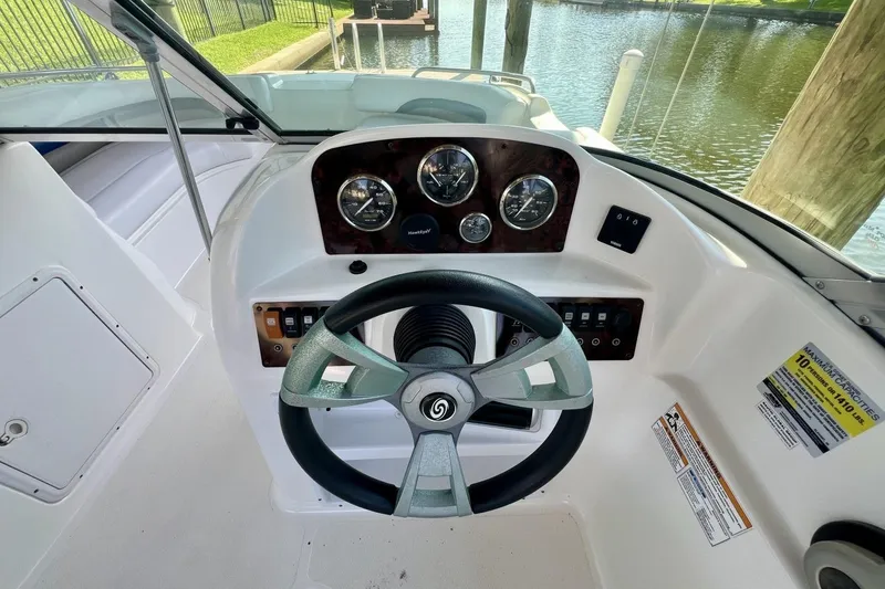 Slide: The Image of 2013 Hurricane SunDeck 187 OB boat dashboard with steering wheel and gauges. - 23