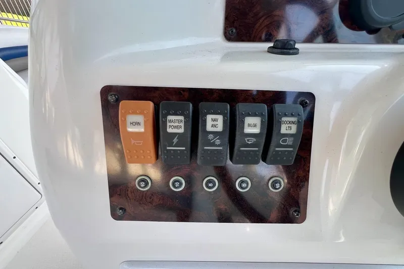 Slide: The Image of Control panel of a 2013 Hurricane SunDeck 187 OB boat with labeled switches. - 25
