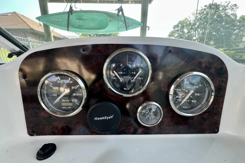 Slide: The Image of Dashboard of a 2013 Hurricane SunDeck 187 OB boat with gauges and controls. - 26