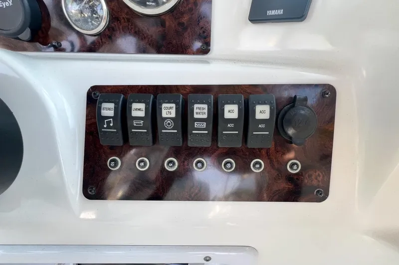 Slide: The Image of Control panel of a 2013 Hurricane SunDeck 187 OB boat with labeled switches. - 27