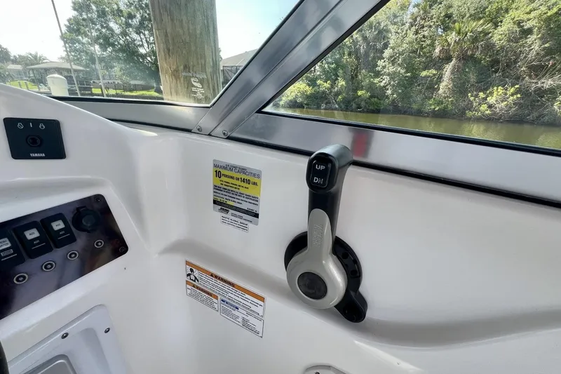 Slide: The Image of Interior view of a 2013 Hurricane SunDeck 187 OB boat, featuring control panel and throttle. - 29