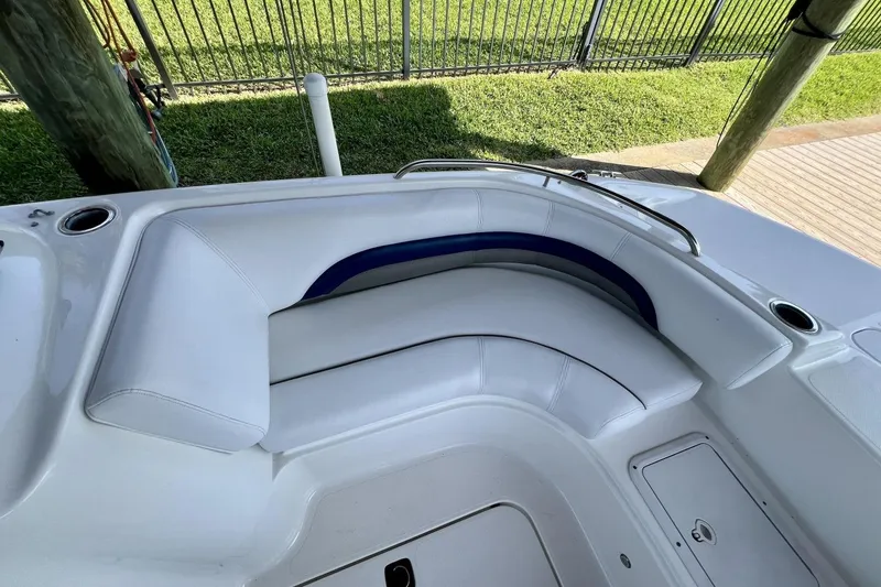 Slide: The Image of 2013 Hurricane SunDeck 187 OB boat interior with white seating and cup holders. - 33
