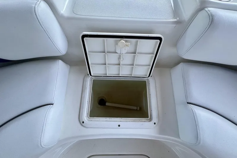 Slide: The Image of Open storage compartment on 2013 Hurricane SunDeck 187 OB boat with white seating. - 36