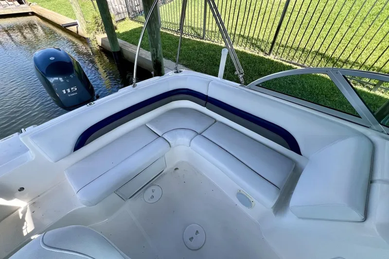 Slide: The Image of 2013 Hurricane SunDeck 187 OB boat interior with white seating and Yamaha 115 outboard motor. - 45