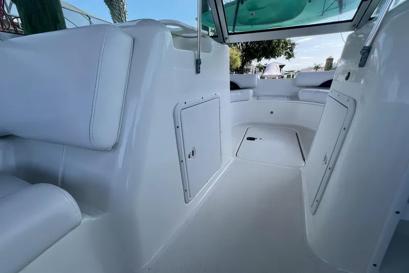 Slide: The Image of Interior view of 2013 Hurricane SunDeck 187 OB boat, featuring white seating and storage compartments. - 50