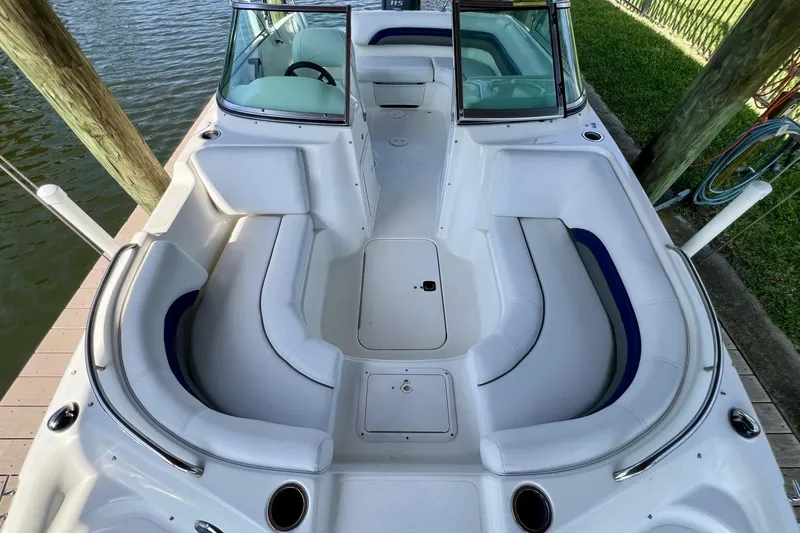 Slide: The Image of 2013 Hurricane SunDeck 187 OB boat with spacious seating, docked by the water. - 57