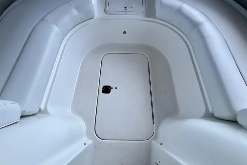 Slide: The Image of 2013 Hurricane SunDeck 187 OB boat interior with white seating and storage compartment. - 59