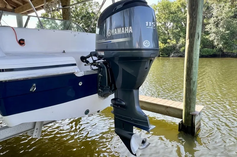 Slide: The Image of 2013 Hurricane SunDeck 187 OB with Yamaha 115 outboard motor on a dock. - 71