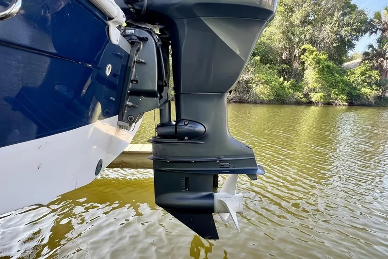 Slide: The Image of 2013 Hurricane SunDeck 187 OB boat motor on calm water, surrounded by lush greenery. - 72