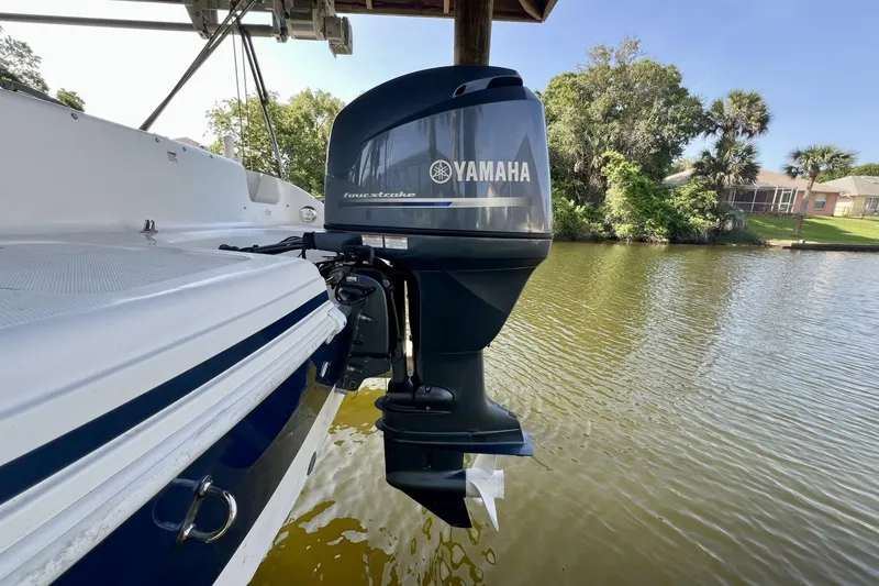 Slide: The Image of 2013 Hurricane SunDeck 187 OB with Yamaha outboard motor on a calm lake. - 73