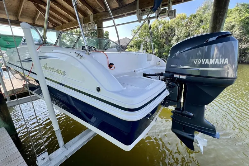 Slide: The Image of 2013 Hurricane SunDeck 187 OB boat with Yamaha outboard motor on a lift. - 74