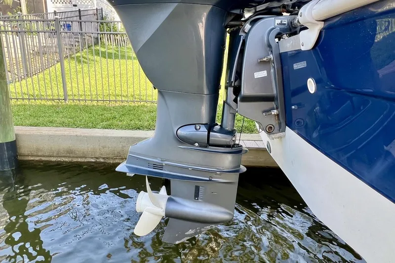 Slide: The Image of 2013 Hurricane SunDeck 187 OB boat motor in water, showcasing propeller and hull design. - 77