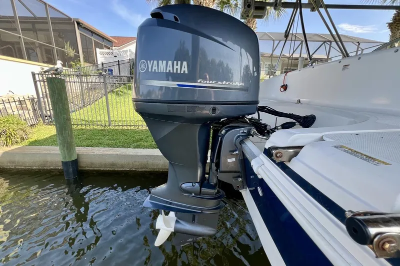 Slide: The Image of 2013 Hurricane SunDeck 187 OB with Yamaha outboard motor docked by water. - 78