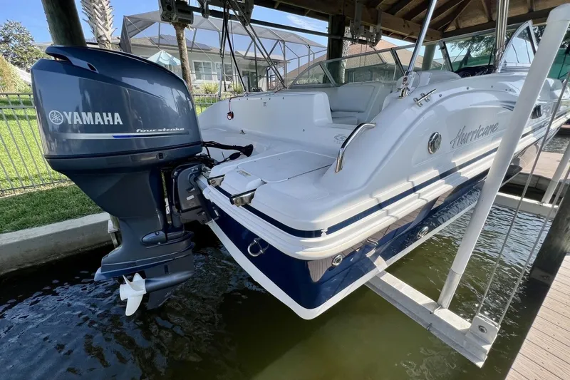 Slide: The Image of 2013 Hurricane SunDeck 187 OB boat with Yamaha outboard motor on a lift. - 79