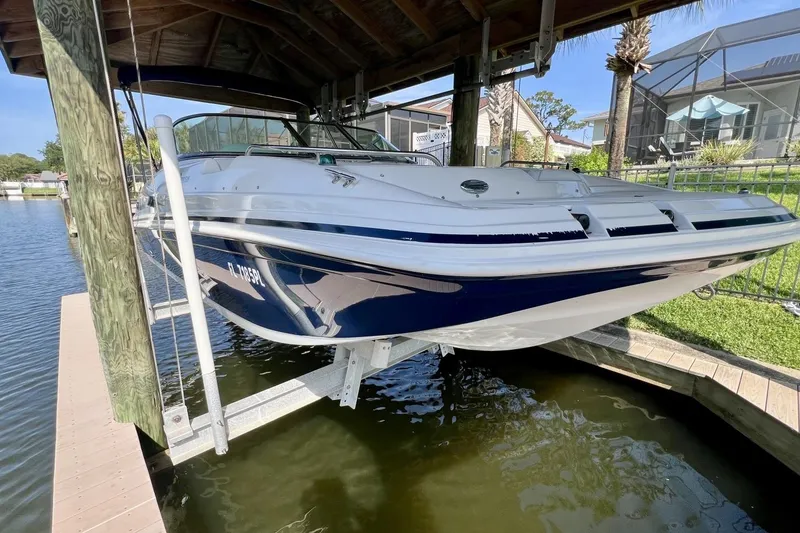 Slide: The Image of 2013 Hurricane SunDeck 187 OB boat docked under a wooden canopy. - 81