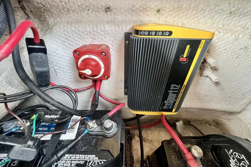 Slide: The Image of Battery compartment of 2013 Hurricane SunDeck 187 OB with charger and wiring. - 85