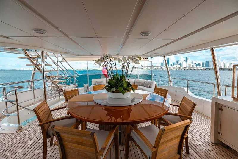 Slide: The Image of Luxurious Benetti Classic Supreme 132 yacht deck with dining area, overlooking city skyline, 2012 model. - 11