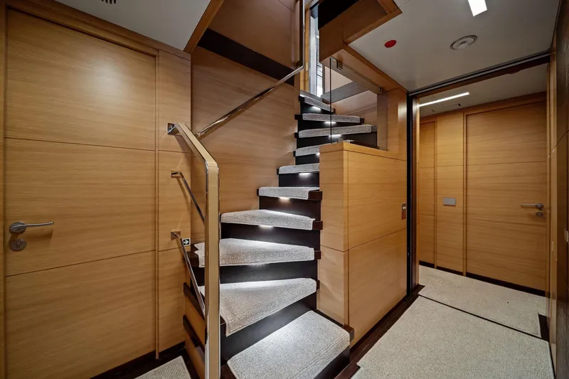 Slide: The Image of Luxurious interior staircase of 2012 Benetti Classic Supreme 132 yacht, featuring modern wood paneling. - 47
