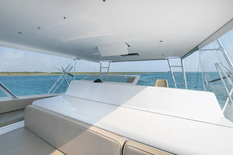 Slide: The Image of 2005 Viking Convertible yacht interior with ocean view, featuring sleek design and comfortable seating. - 11